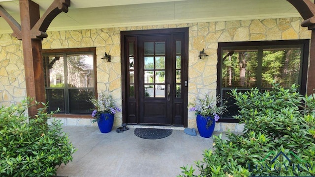 4350 Fm 1650, Gilmer, TX 75645 - doorway to property with stone siding and covered porch