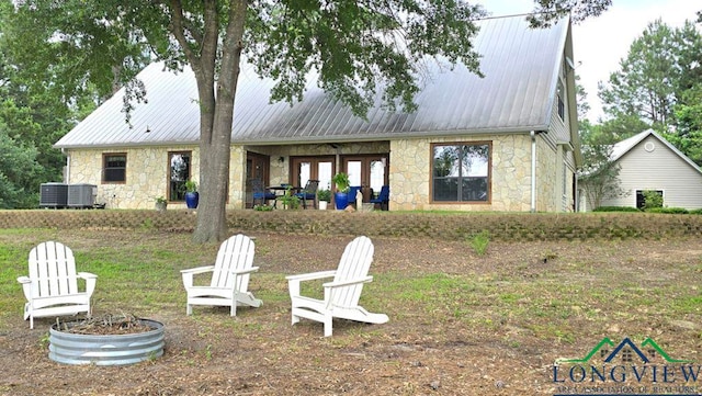 4350 Fm 1650, Gilmer, TX 75645 - back of house featuring stone siding and a metal roof