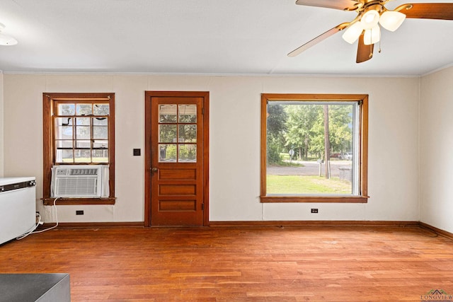 interior space with ceiling fan, cooling unit, and light wood-type flooring