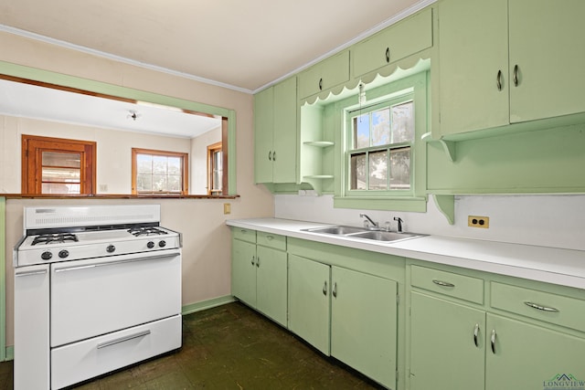 kitchen featuring crown molding, green cabinetry, gas range gas stove, and sink