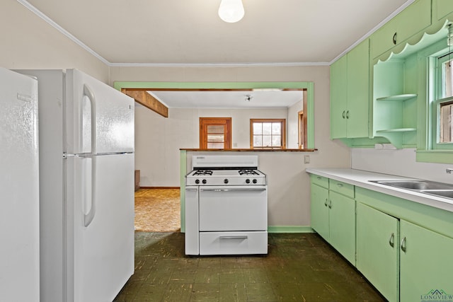 kitchen featuring white appliances, green cabinetry, ornamental molding, and sink