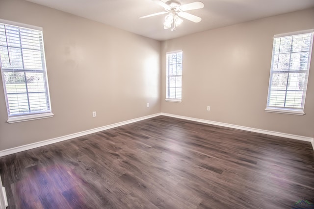 empty room with ceiling fan and dark wood-type flooring