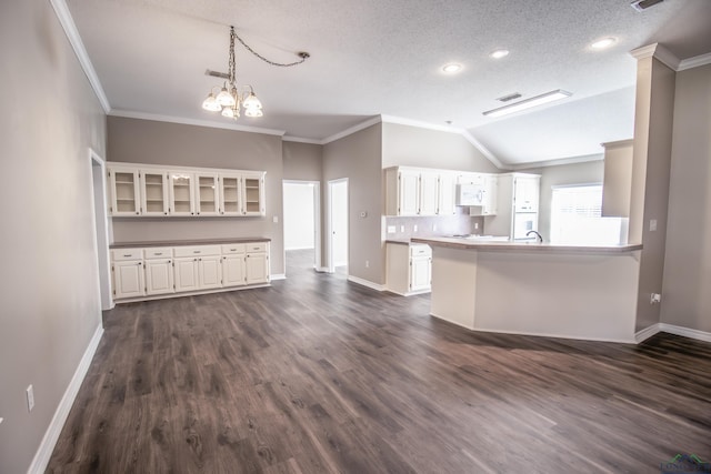 unfurnished living room with a textured ceiling, crown molding, and lofted ceiling