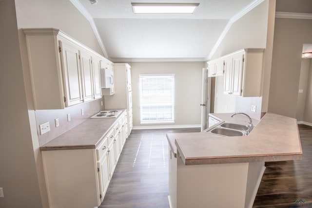 kitchen with lofted ceiling, white appliances, sink, kitchen peninsula, and a breakfast bar area