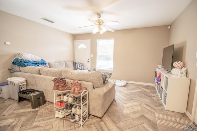 living room featuring light parquet flooring and ceiling fan