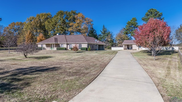 ranch-style home featuring a front yard and a garage