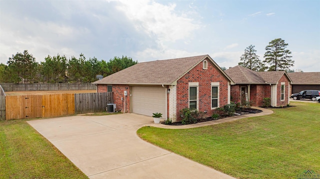 view of front of home with a front lawn, a garage, and central AC unit