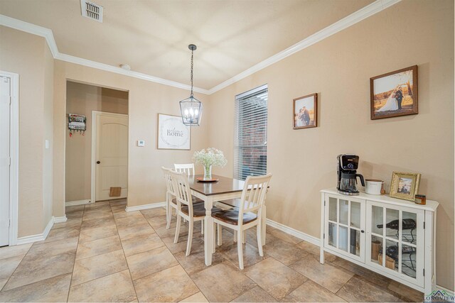 dining room with an inviting chandelier and ornamental molding