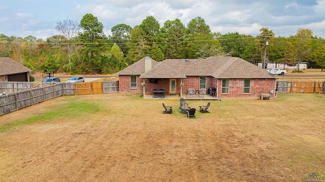 back of house with a patio area and a lawn