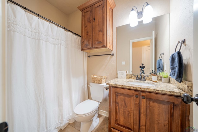 bathroom featuring tile patterned flooring, vanity, and toilet