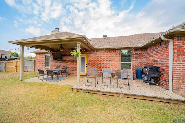 view of patio with ceiling fan, area for grilling, and a wooden deck