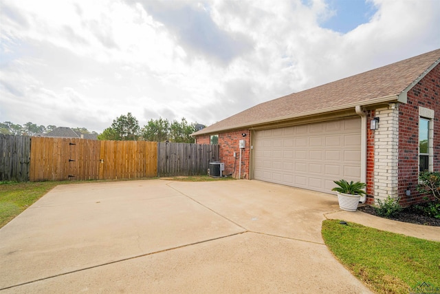 exterior space featuring a garage and cooling unit