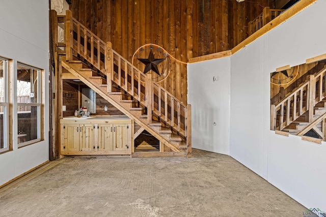 unfurnished living room with wooden walls