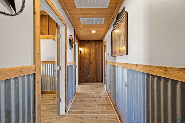 hall with wooden ceiling and wood walls