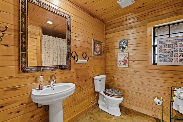 bathroom featuring wood ceiling, wooden walls, and toilet