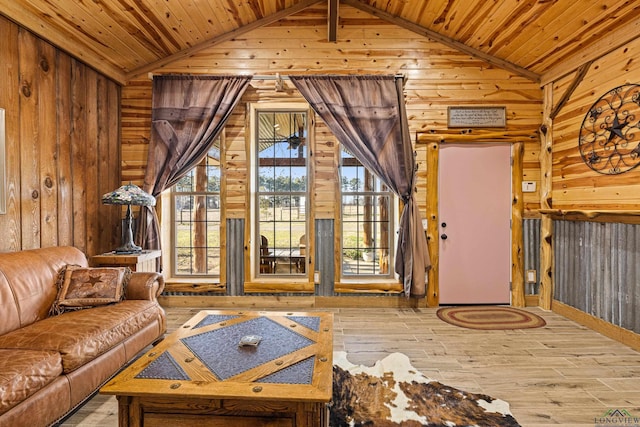 living room featuring high vaulted ceiling, light wood-type flooring, wooden walls, and wood ceiling