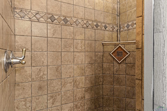 bathroom with tiled shower