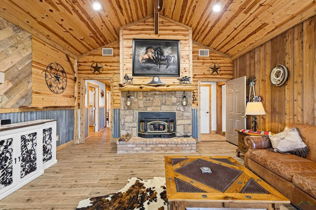 living room featuring wood walls, hardwood / wood-style floors, vaulted ceiling, and wood ceiling