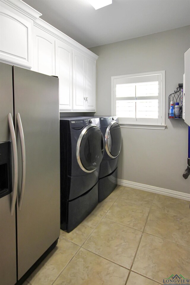 24130 Stallion Park Pl, Lindale, TX 75771 - laundry area with washing machine and dryer, baseboards, cabinet space, and light tile patterned flooring