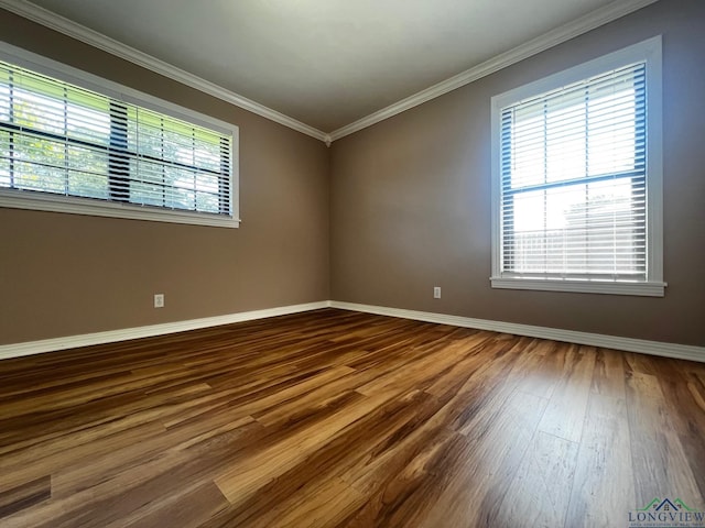 empty room with wood-type flooring and ornamental molding