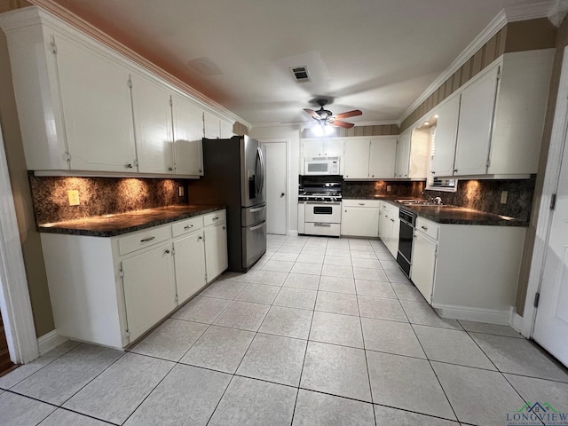 kitchen with ceiling fan, sink, light tile patterned flooring, white appliances, and white cabinets