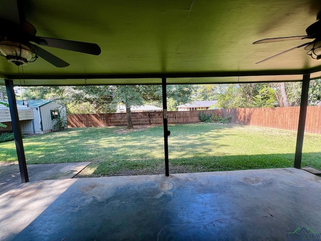 view of patio / terrace with a shed and ceiling fan