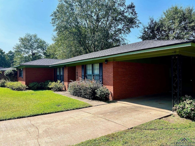 ranch-style house featuring a front yard and a carport