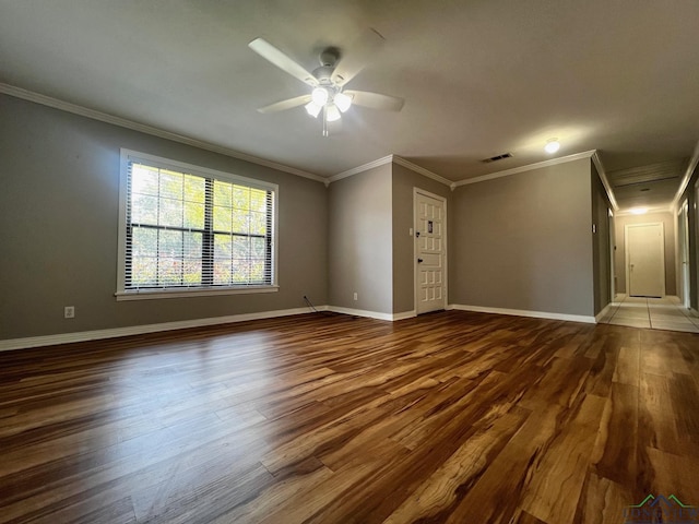 empty room featuring ceiling fan, ornamental molding, and hardwood / wood-style flooring