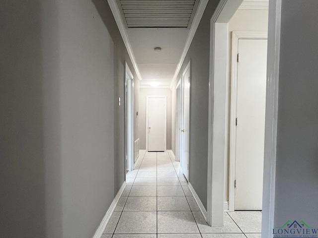 corridor featuring crown molding and light tile patterned floors