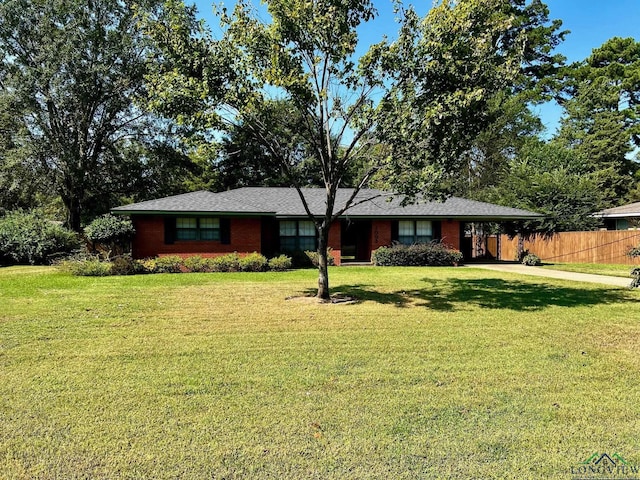 ranch-style home with a front yard and a carport