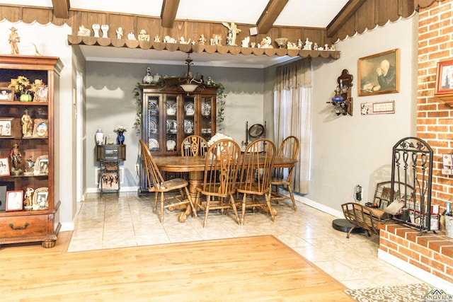 tiled dining area with beamed ceiling