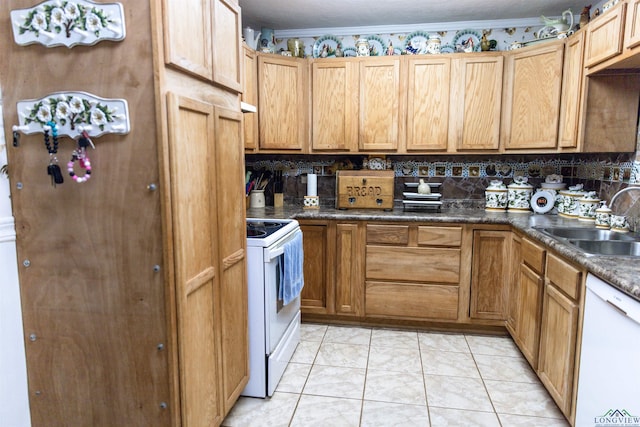 kitchen featuring sink, white appliances, decorative backsplash, light tile patterned floors, and ornamental molding