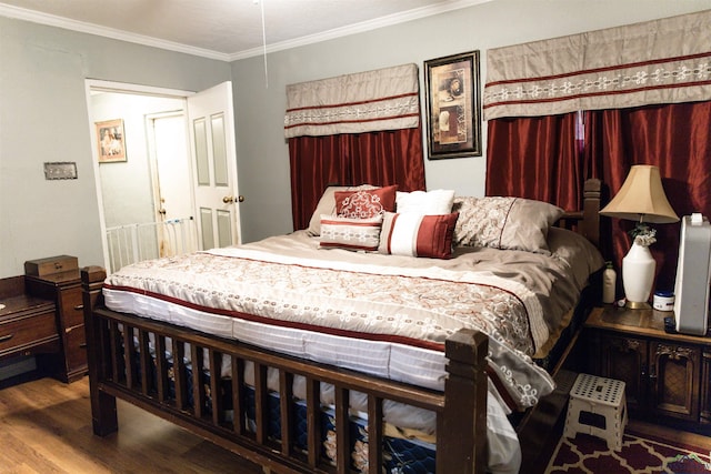 bedroom with hardwood / wood-style floors and ornamental molding