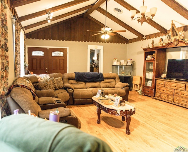 living room with hardwood / wood-style flooring, lofted ceiling with beams, and ceiling fan with notable chandelier