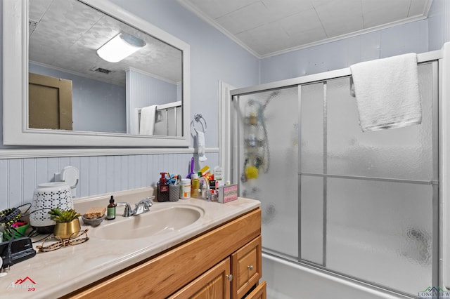 bathroom featuring visible vents, ornamental molding, bath / shower combo with glass door, and vanity