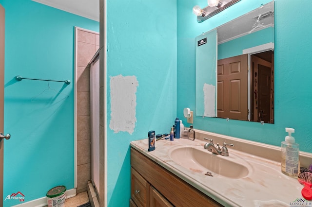 bathroom with crown molding, vanity, and a stall shower