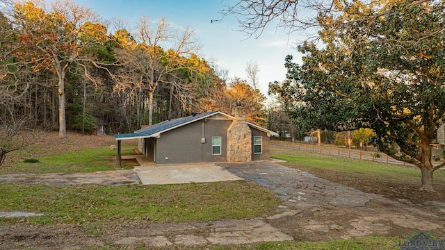 view of side of property featuring a yard