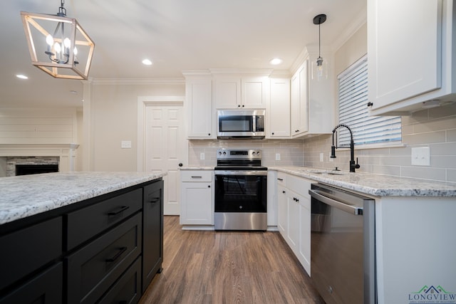 kitchen featuring white cabinets, pendant lighting, stainless steel appliances, and sink