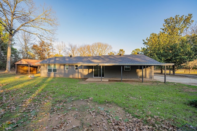 back of property featuring a lawn