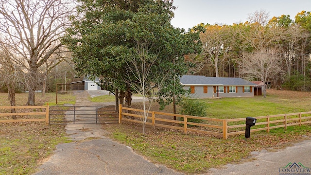 view of front of house with a rural view and a front yard