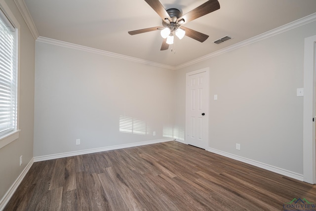 empty room with dark hardwood / wood-style floors, ceiling fan, and crown molding