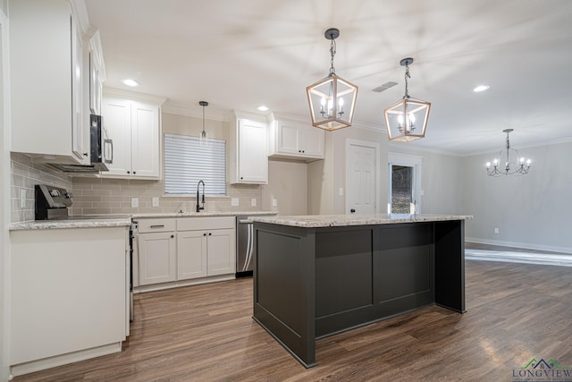 kitchen with a kitchen island, dark wood-type flooring, sink, white cabinetry, and hanging light fixtures