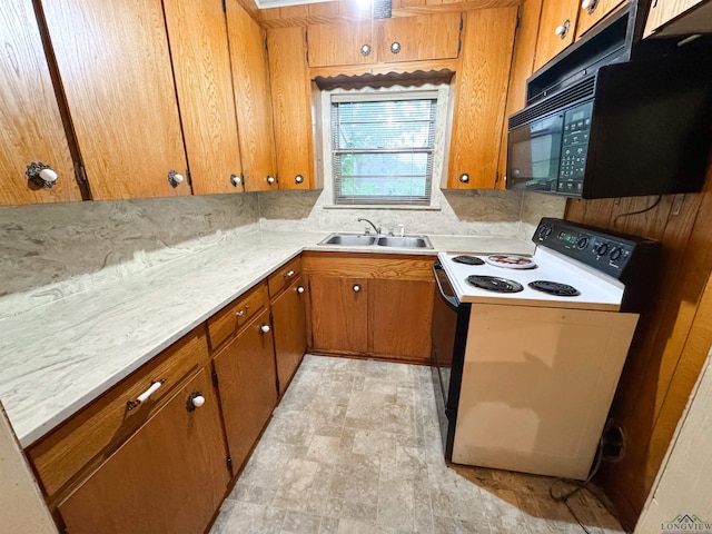 kitchen featuring white electric range and sink