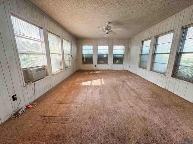 unfurnished sunroom with cooling unit and ceiling fan