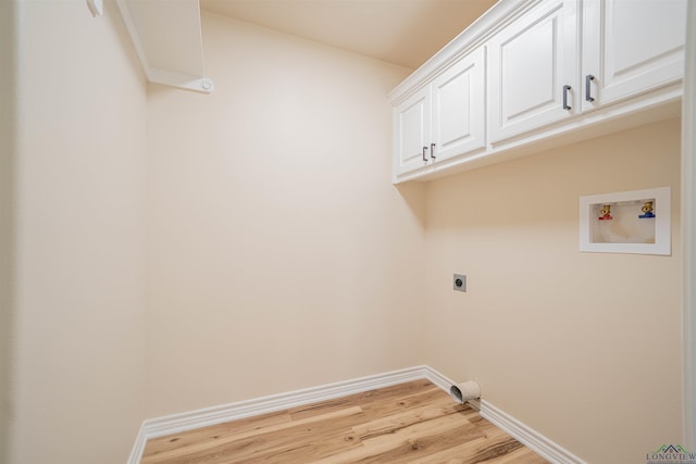 3603 Stracener Rd, Longview, TX 75605 - laundry area with hookup for an electric dryer, cabinet space, light wood-style flooring, baseboards, and washer hookup