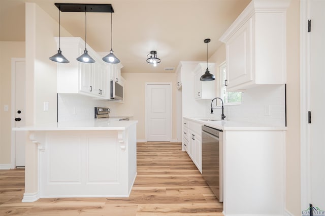 3603 Stracener Rd, Longview, TX 75605 - kitchen featuring a sink, stainless steel appliances, light wood-style floors, and backsplash