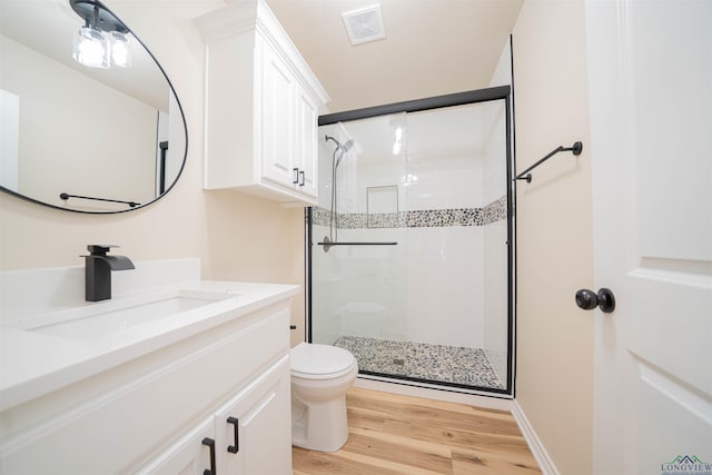 3603 Stracener Rd, Longview, TX 75605 - full bathroom featuring toilet, a stall shower, wood finished floors, and vanity