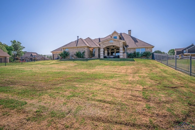 111 Winifreds Way, Hallsville, TX 75650 - back of property with brick siding, a lawn, a fenced backyard, and a chimney