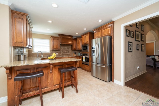 111 Winifreds Way, Hallsville, TX 75650 - kitchen with backsplash, a peninsula, light stone countertops, and stainless steel appliances