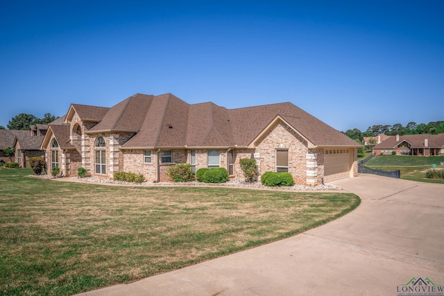 111 Winifreds Way, Hallsville, TX 75650 - view of front of home featuring concrete driveway, an attached garage, a front yard, brick siding, and roof with shingles